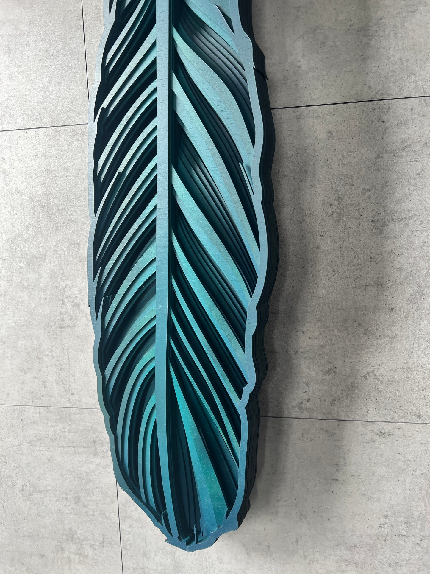 Tui feather wall art side view displaying 3D layered construction
