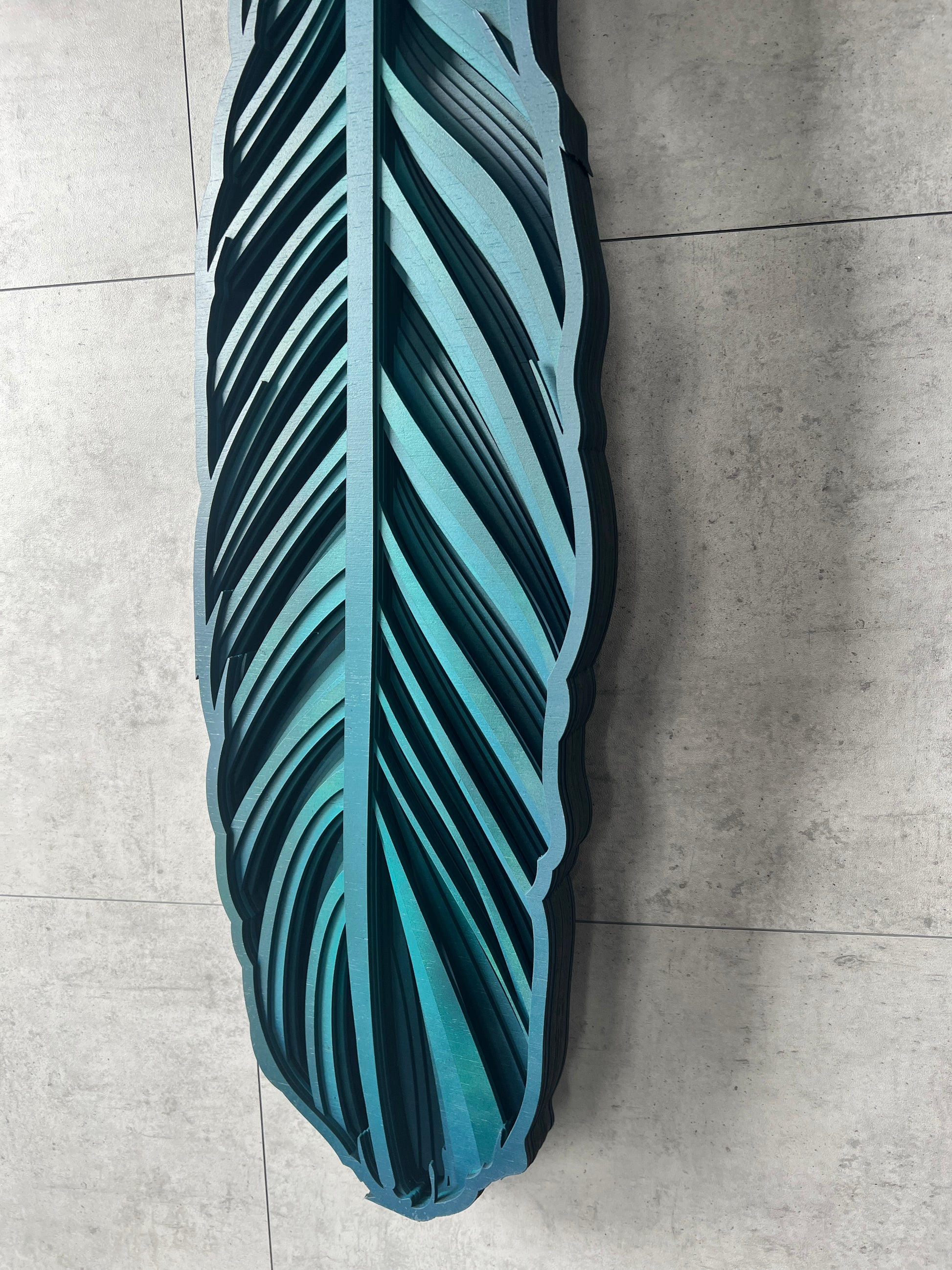 Tui feather wall art side view displaying 3D layered construction