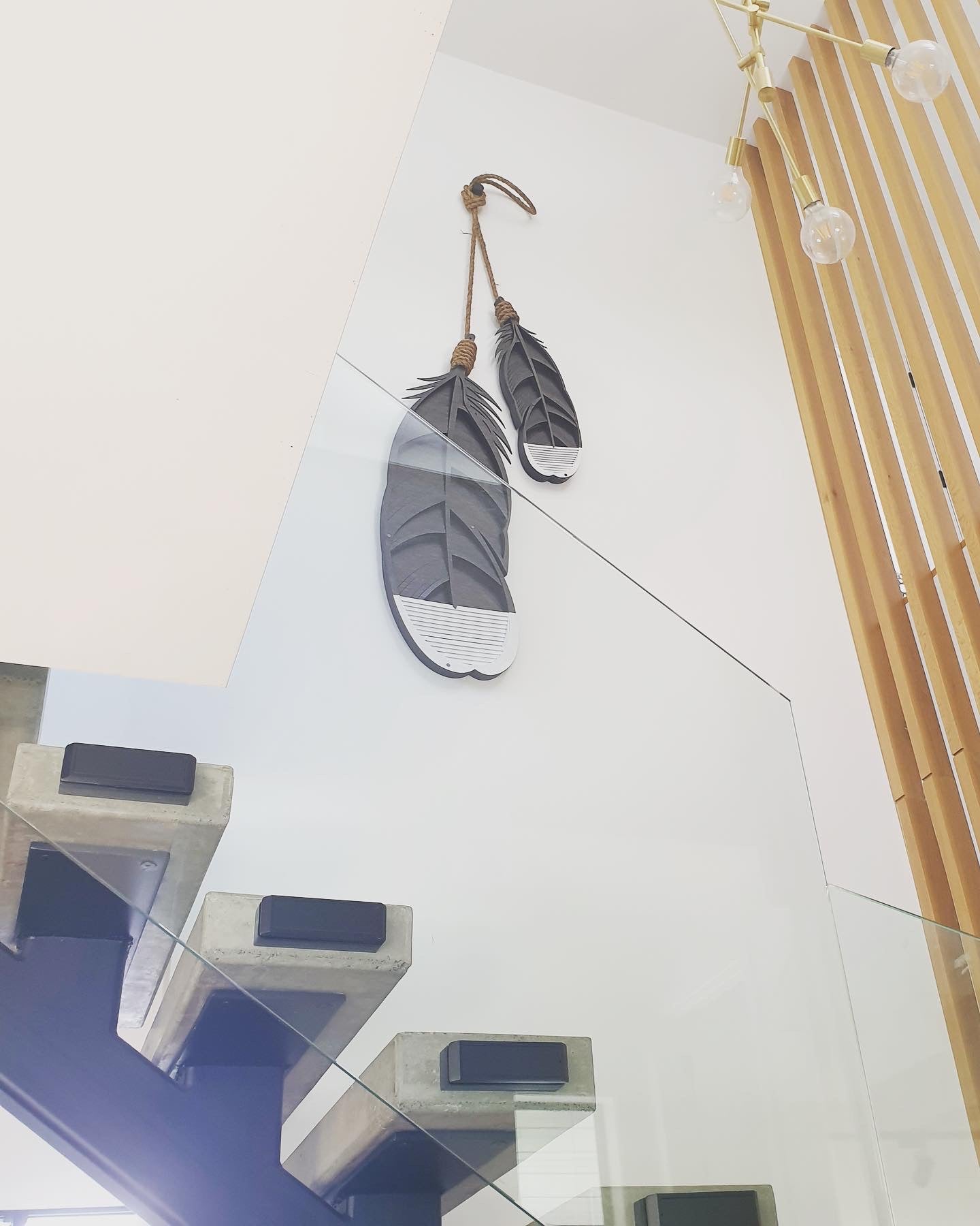 Huia feather wall art lifestyle shot showing scale and hanging display