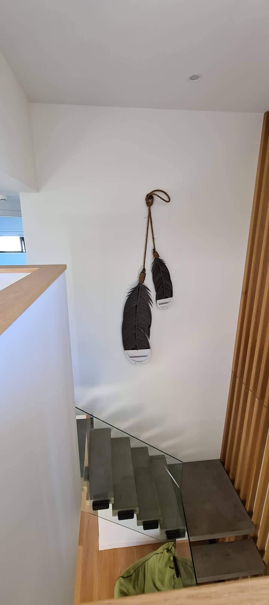 Huia feather wall art lifestyle shot showing scale and hanging display