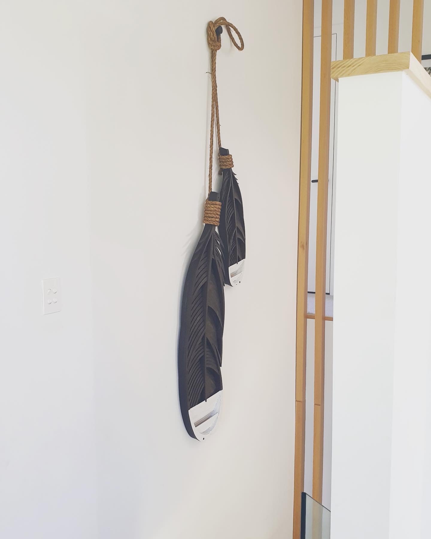 Huia feather wall art angle view displaying 3D layered effect