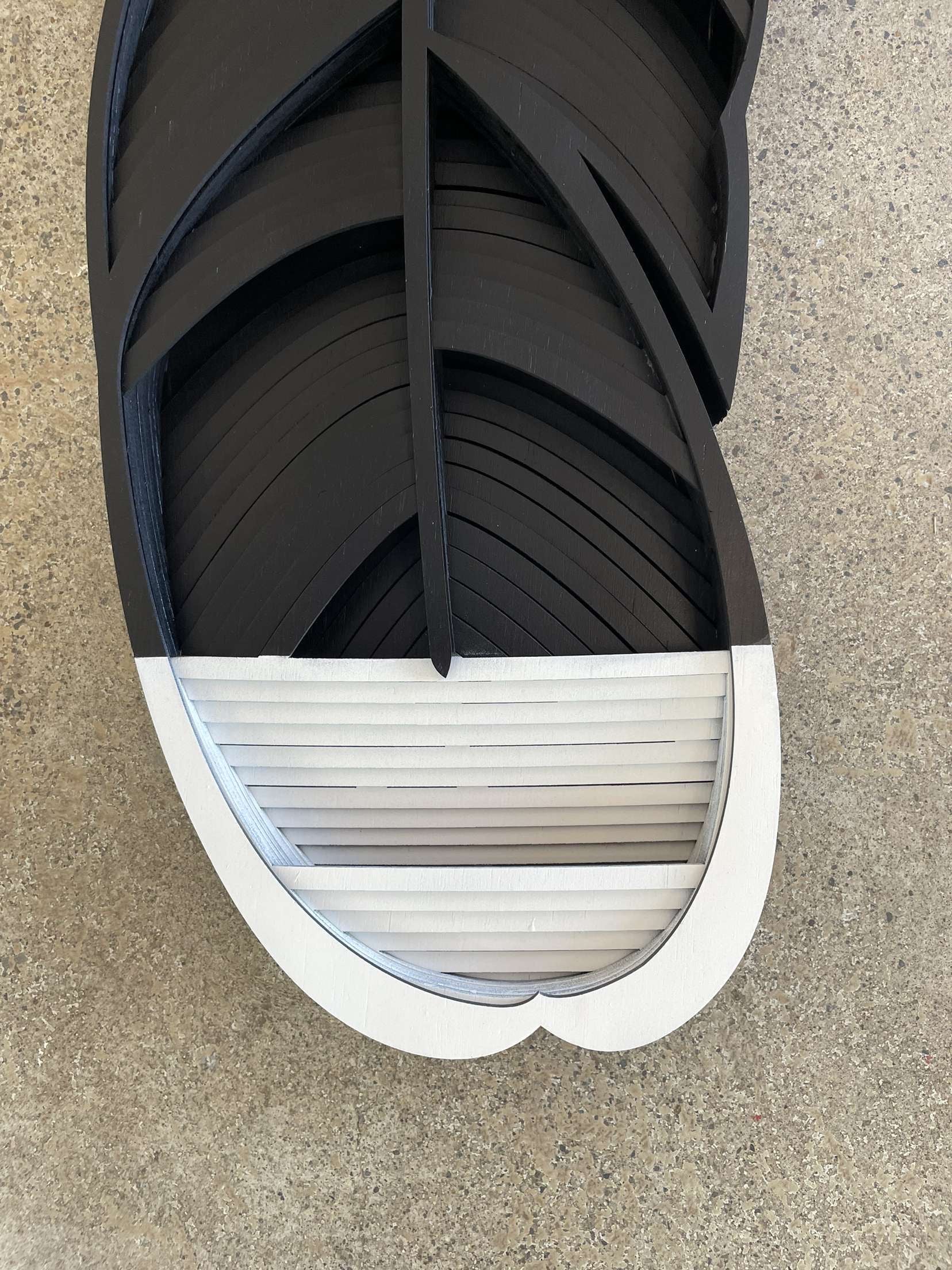 Close-up of Huia feather showing hand-painted black and white detail