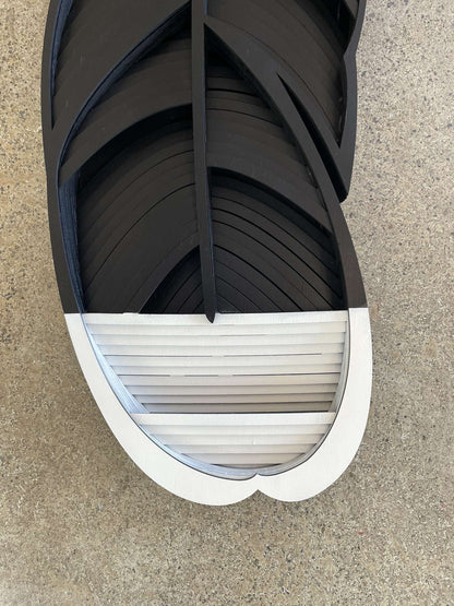 Close-up of Huia feather showing hand-painted black and white detail