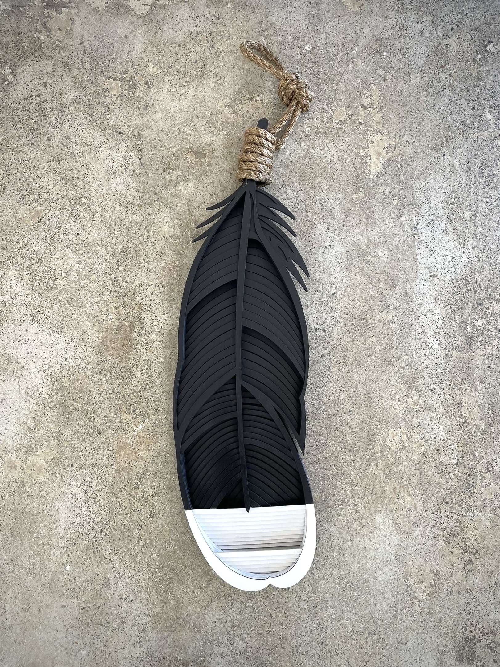 Huia feather wall art close-up showing intricate painted detail