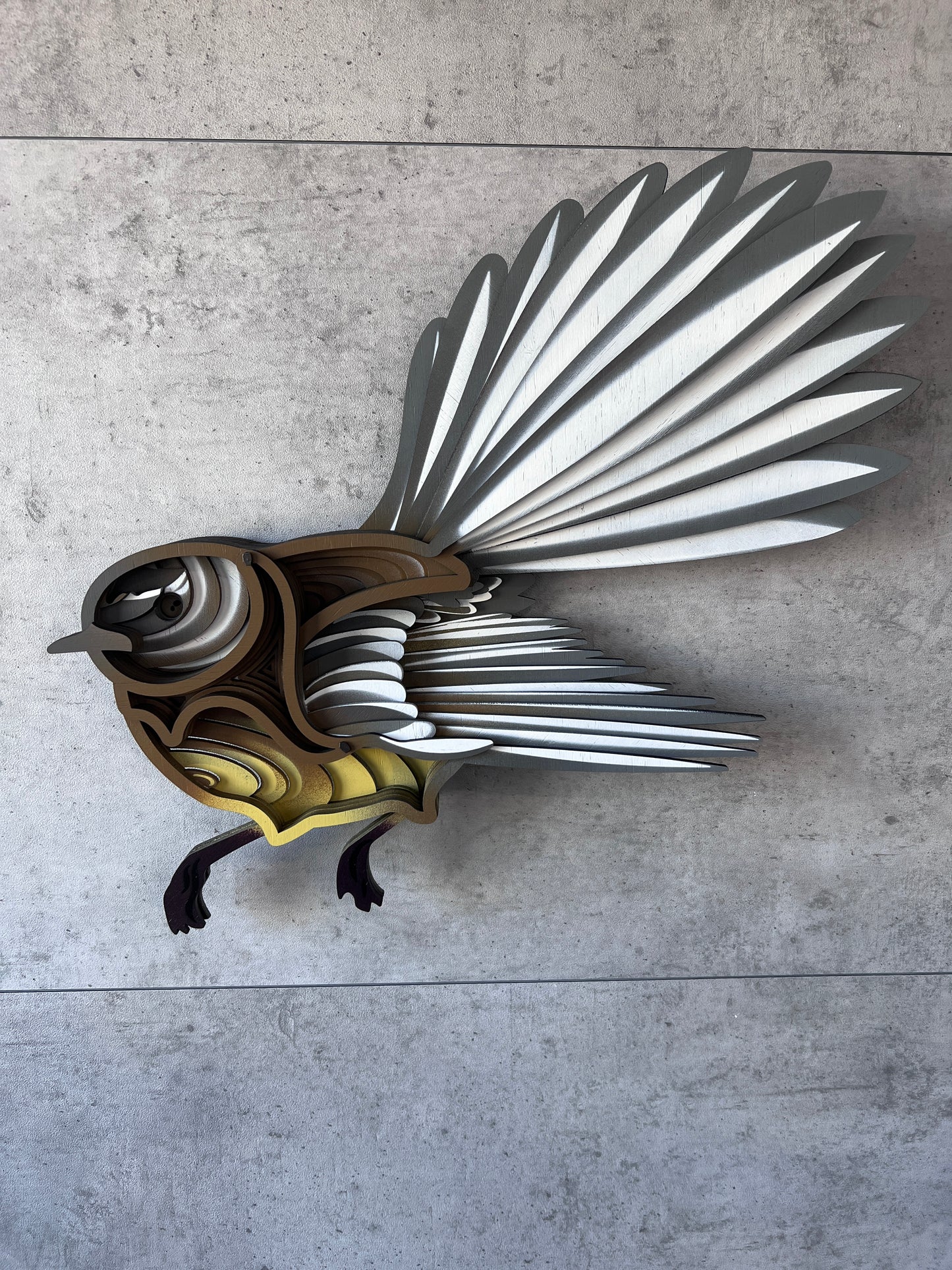 Fantail wall art detail showing hand-painted feathers and bamboo texture