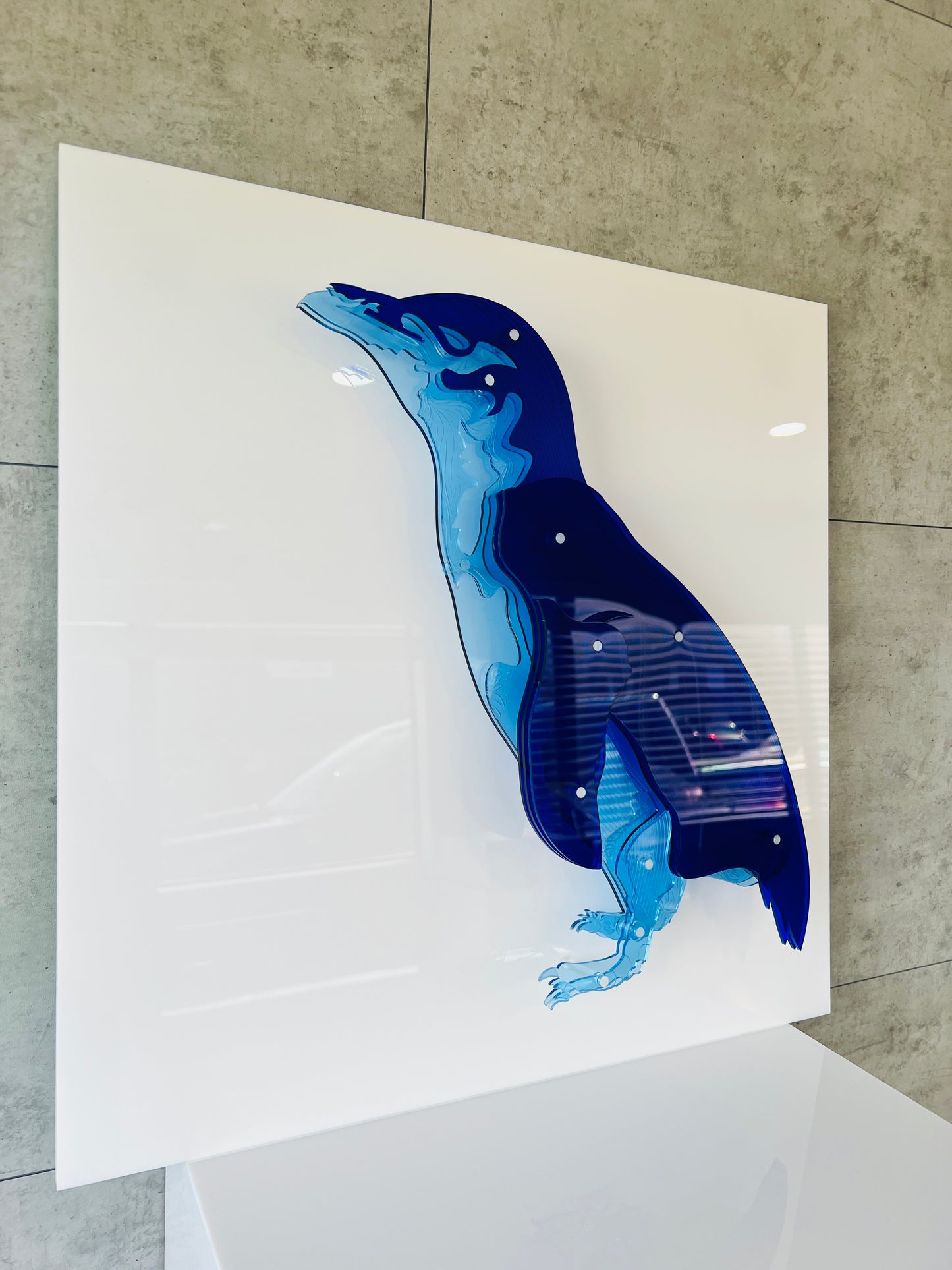Blue Penguin side view in display case showing 3D depth effec